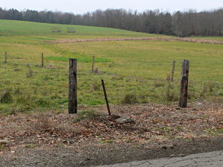 A view to the SW, showing the proximity of the monument to the edge of the pavement.