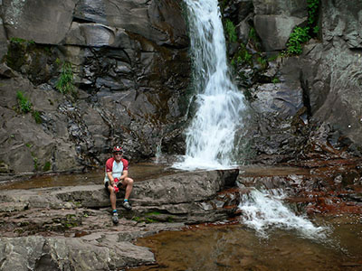 Rich sits near the small pool at the base of Buttermilk Falls.