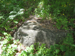 Eyelevel view of the chiseled square on the boulder.