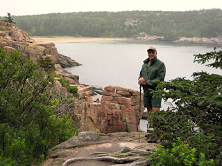 Rich finds a colorful spot high above the waves. Sand Beach is in the background.