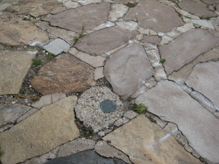 Eyelevel view of the disk set in stone. Disk set in stone.