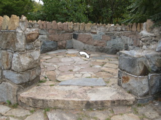 Circular stone platform around the mark.