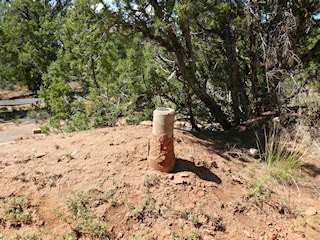 Eyelevel view of the concrete post in earthen mound.