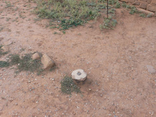 Eyelevel view of the small NPS disk in the concrete monument.