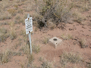 Eyelevel view of the azimuth mark set in concrete, and the witness sign.