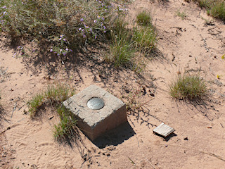 Eyelevel view of the reference mark in the concrete monument.