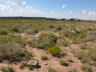 Construction vehicles and a small mesa to the north.