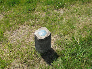 Eyelevel view of the disk set into the concrete monument.