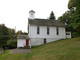 Looking S toward the church. I searched the walkway to the left of, and wrapping around, the church.