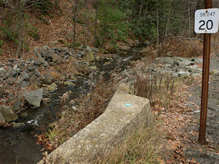 Eyelevel view of the disk on the concrete bridge headwall.