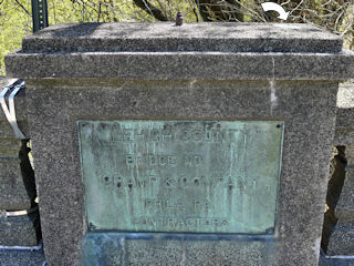 Benchmark (indicated) on top of bridge bannister. The bridge builders’ plate is below, but the bridge number is not indicated.