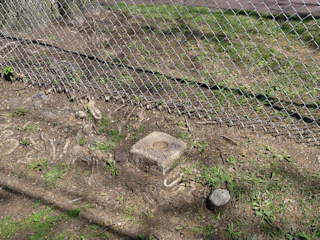 Eyelevel view of the reference mark disk set into the concrete monument.