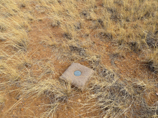 Eyelevel view of the disk in the square concrete monument