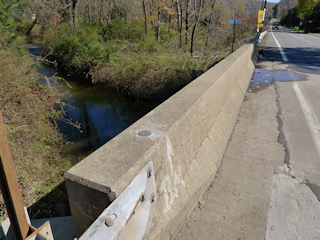 Eyelevel view of the disk set into the west end of the north sidewall of the bridge.