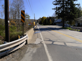 Looking SE along Route 438. The intersection with Route 524 is across the bridge and to the right.