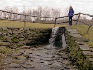 After a warm winter, there is just a sliver of ice remaining near this small waterfall.