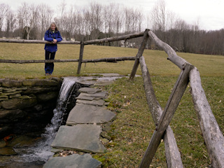 Another view of the waterfall and the fence surrounding it.