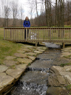 Further upstream, Zhanna admires how the entire creekbed is lined with coping stones.