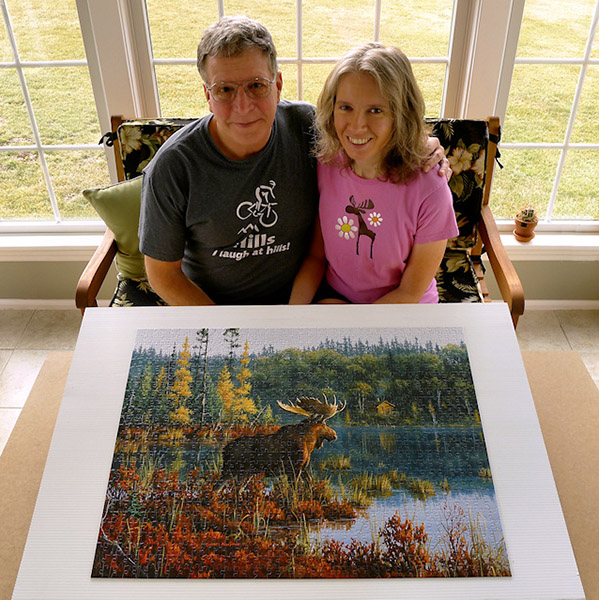 Rich and Zhanna in the sunroom, with a moose puzzle.