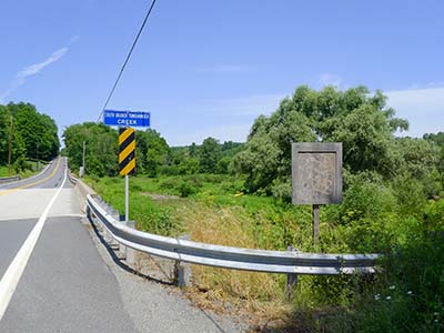 Also looking NW; wider view shows creek and watershed signage