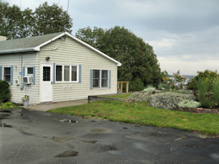 The small cottage next to the rock garden.