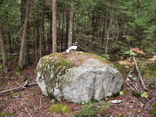 The boulder is very conspicuous.