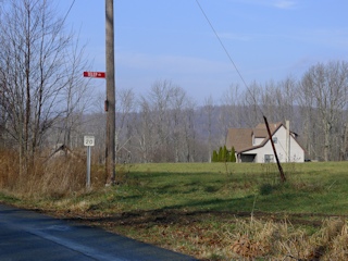 The adjacent field and sign for the ‘road SW’ (Telep Rd.) mentioned in the description.