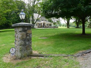 Post near entranceway, showing one address.