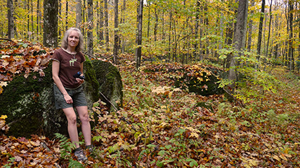 Zhanna rests against one of the large boulders along the Whitetail Trail.