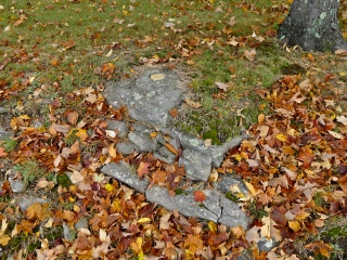 Eyelevel view of the survey mark set into the rock outcrop.