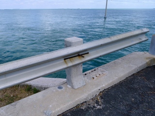 Eyelevel view of the disk on the northwest curb of the old bridge over Channel #2.