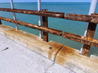 Eyelevel view of the disk on the concrete curb of the bridge.