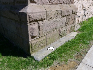 Eyelevel view of the chiseled mark on the foundation.