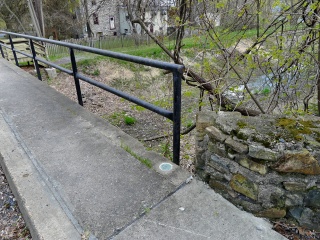 Eyelevel view of the disk in the sidewalk.