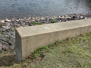 Eyelevel view of the disk in the concrete wingwall.