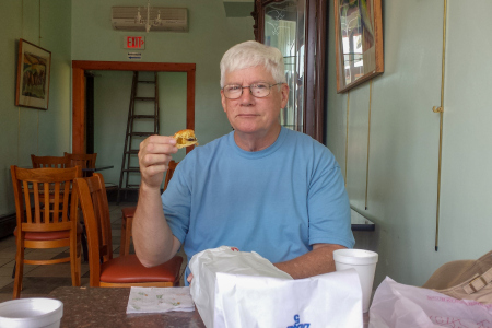 Dad eating his favorite at Cohen's Bakery—the prune strip!