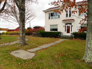 Eyelevel view of the disk in the flagstone walk showing proximity to house.