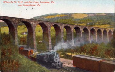 This early 1900s postcard shows the Erie crossing on the viaduct over the D&H ROW (north end of the viaduct).