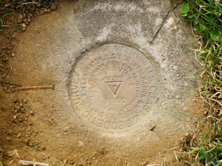 The three nails point in the direction of the RMs and the azimuth mark.