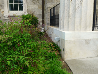 Eyelevel view of the disk set vertically on the courthouse foundation.