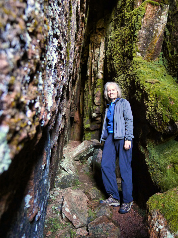 The cave is narrow and mossy.