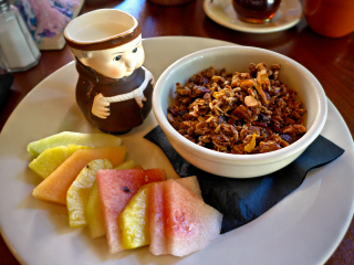 Granola, under the watchful eye of the friar