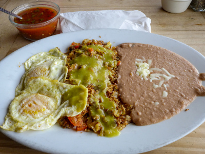 Machaca with over-medium eggs, crisp flour tortilla, and verde sauce