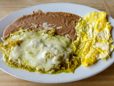 Chilaquiles with verde sauce, scrambled eggs and beans
