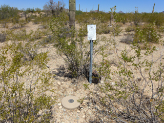 Eyelevel view of the disk on the monument and the intact witness post