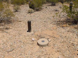 Eyelevel view of the disk on the monument, and the witness post