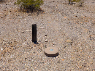 Eyelevel view of the disk on the monument, and the witness post