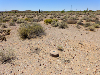 Eyelevel view of the disk on the monument and former location of the witness post