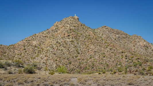 The cross stands on Camelback Mountain in Ajo.