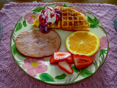 Cornmeal waffles with blueberry sauce and vanilla ice cream, ham and fresh fruit